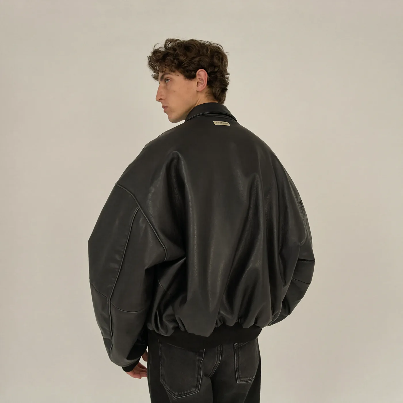 Man wearing Buneri black oversized leather bomber jacket